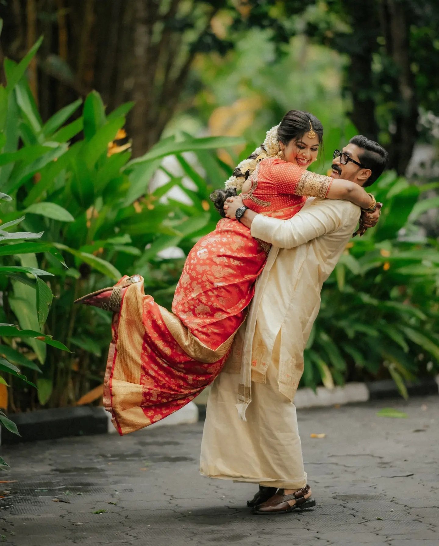 Groom lifting his bride during their portrait session